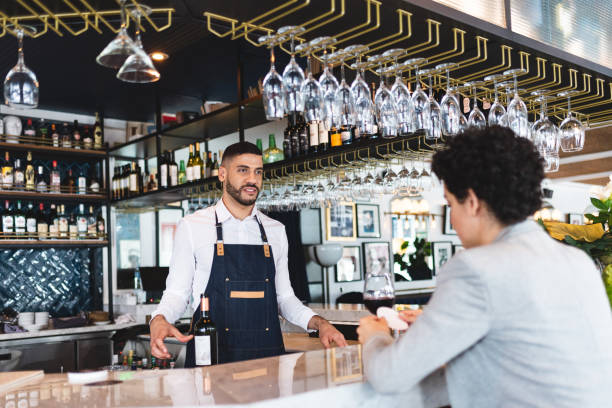 istock Bartender listening to a businesswoman 1276803871