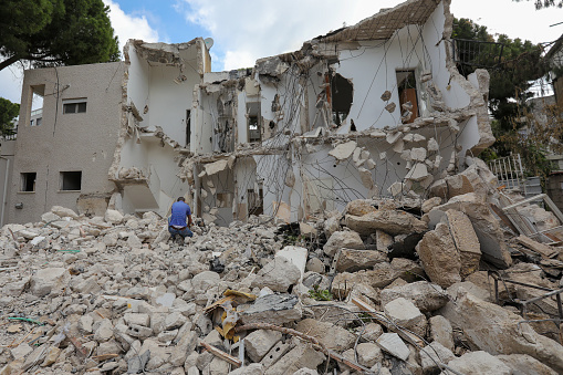 Broken house on ruin demolishing site after destruction