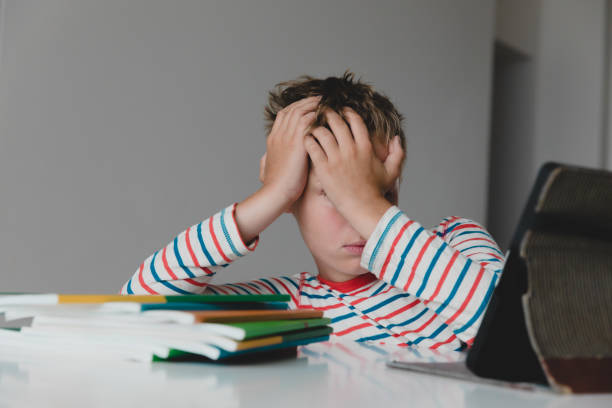 istock Child tired and bored of doing homework, kid stressed from learning indoors 1276804823