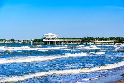 Beach, house with a footbridge in Timmendorfer Strand nearby Lubeck - Travemunde (Travemünde) on baltic sea. Schleswig-Holstein, Germany.