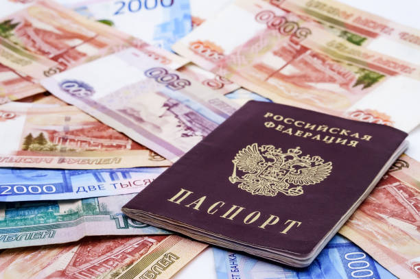 istock Russian passport and money, passport document on Russian banknotes 1276809588