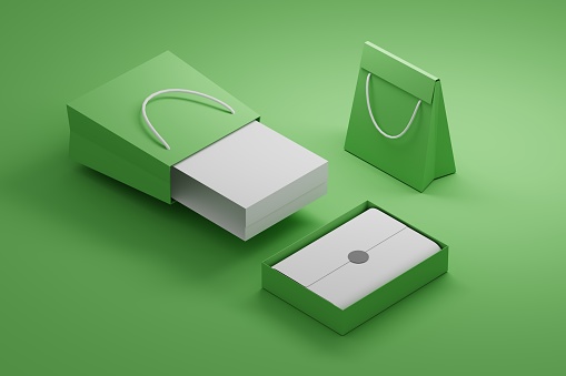 Composition with shopping paper bags and boxes on green background with blank surfaces. 3d illustration.