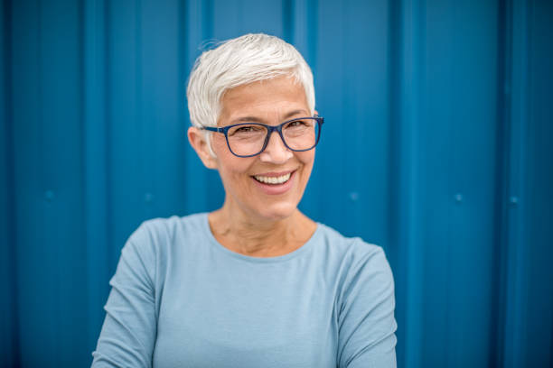 istock Happy senior woman against blue background. 1276810862