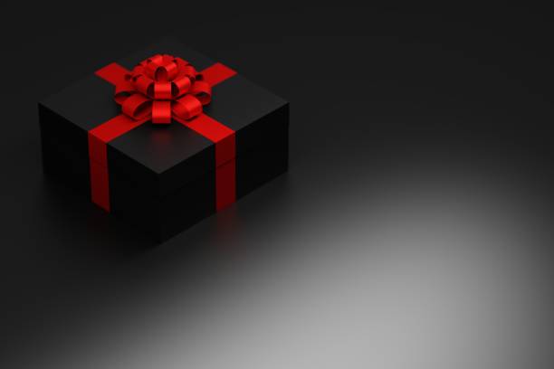 istock Present gift with red shiny bow on dark background 1276811001