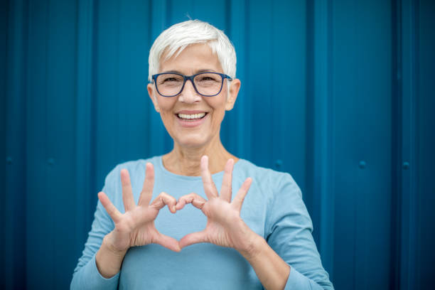 istock Happy senior woman against blue background. 1276813647