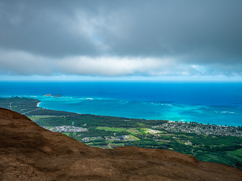 The view overlooking the town.  Blue sky over green mountains. Amazing view of the ocean. \n Kuliouou Ridge Trail, Hawaii, Oahu