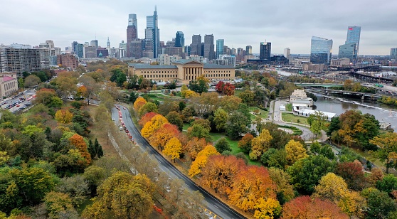 Philadelphia, PA — October 29, 2019: The trees change color for fall by the Philadelphia Museum of Art with a view of the Philadelphia skyline. The Philadelphia Museum of Art is the cultural heart of the city of Philadelphia and contains extensive Impressionist, American, and International art collections. Drone photo by Alyssa Cwanger / www.alyssacwanger.com