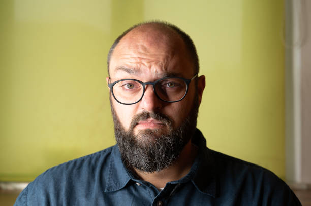 istock Man looks seriously insecure and doubtful into the camera 1276814860