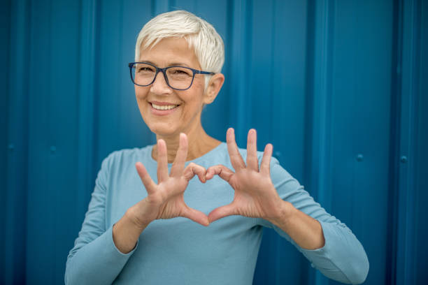 istock Happy senior woman against blue background. 1276815421