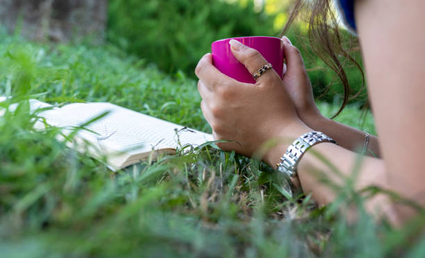 istock relaxing on green grass and Reading book in Spring sunshine day 1276815510