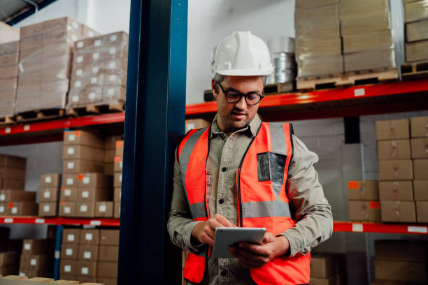 istock Male worker browsing on digital tablet wearing spectacles while standing in factory 1276815984
