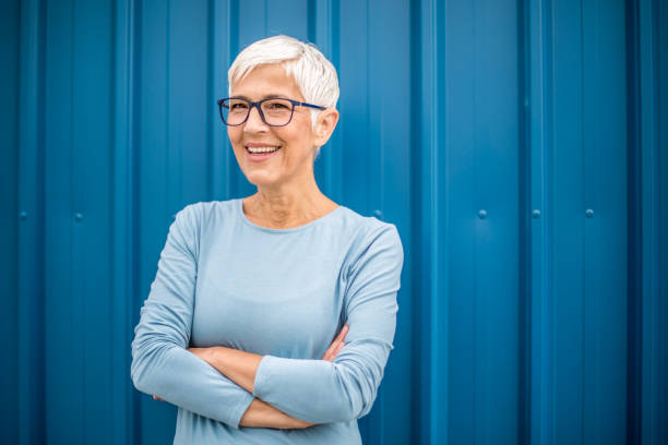 istock Happy senior woman against blue background. 1276816679