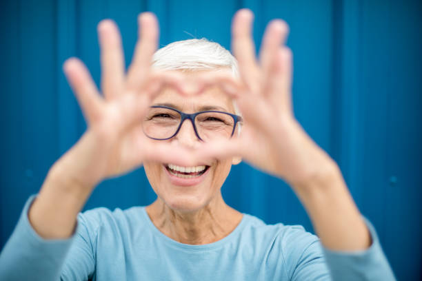 istock Happy senior woman against blue background. 1276816732