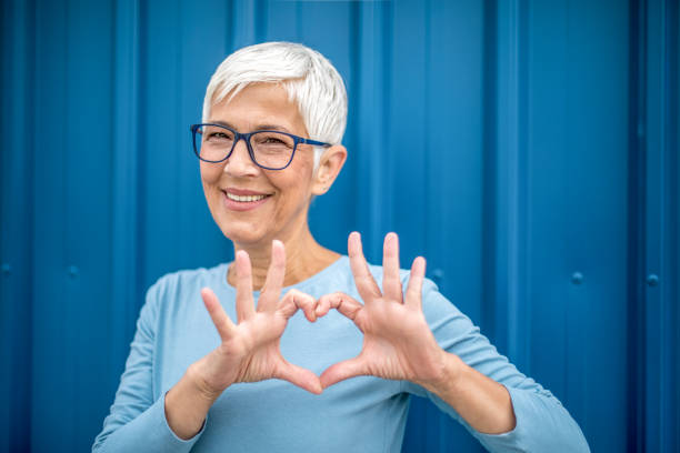 istock Happy senior woman against blue background. 1276817138