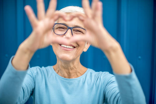 istock Happy senior woman against blue background. 1276817243