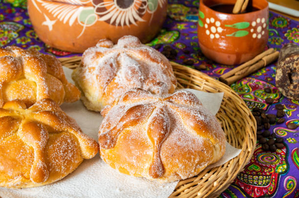 Traditional Mexican bread of the dead (pan de muerto) with coffe Traditional Mexican bread of the dead (pan de muerto) served with coffee from the pot (cafe de olla), this bread is made around the day of the dead celebration and is often left on altars of remembrance day of the dead photos stock pictures, royalty-free photos & images