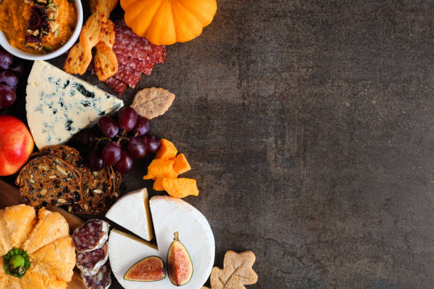istock Autumn charcuterie side border against a dark stone background 1276817880