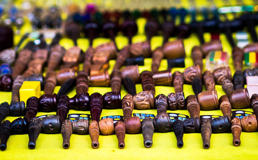 Picture of rows of smoking chillum or chillam pipes on display for sale