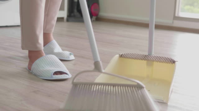 Woman Using Broom to Sweeping the Floor for Cleaning