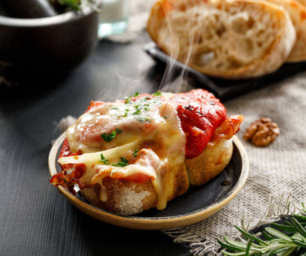 hot grilled sandwich with red pepper, bacon and melted cheese - bruschetta buffet party food imagens e fotografias de stock