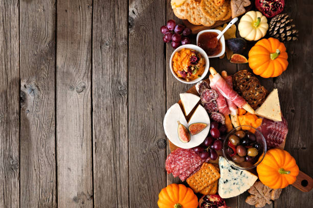 istock Fall charcuterie side border against a dark wood background with copy space. 1276819216