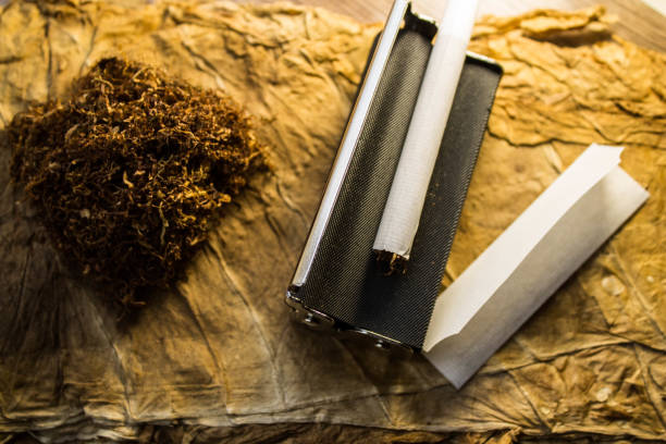 istock Smoking accessories. Machine for twisting cigarettes tobacco and paper. Manufacturing process. 1276824032