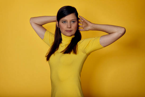 istock Studio shot of mature woman side view looking at camera 1276824333