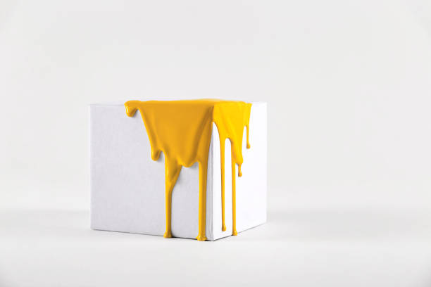 White cube with smudges of bright yellow paint