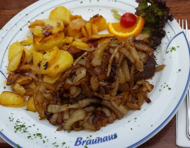 istock delicious fried potatoes German style with beef steak and onions 1276826343