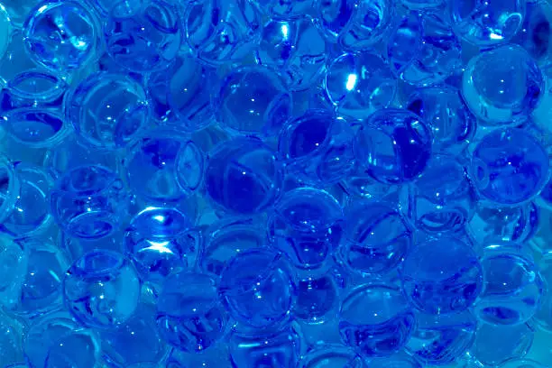 Background of handfuls of transparent and blue orbis close up