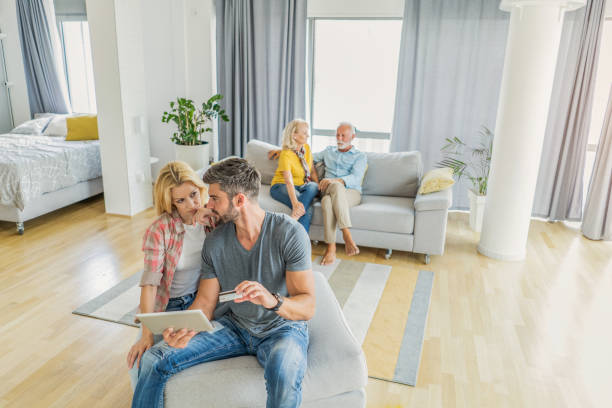 istock Mid adult couple using digital tablet and paying with credit card. 1276834952