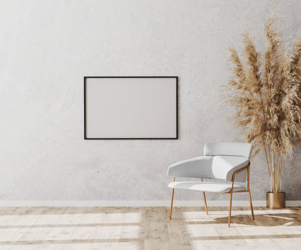 istock Blank picture frame in bright contemporary empty room interior with luxury white chair on wooden parquet floor and white decorative plaster wall, 3d rendering 1276834983