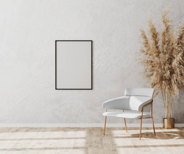 istock Blank poster frame in bright contemporary empty room interior with luxury white chair on wooden parquet floor and white decorative plaster wall, 3d rendering 1276834990