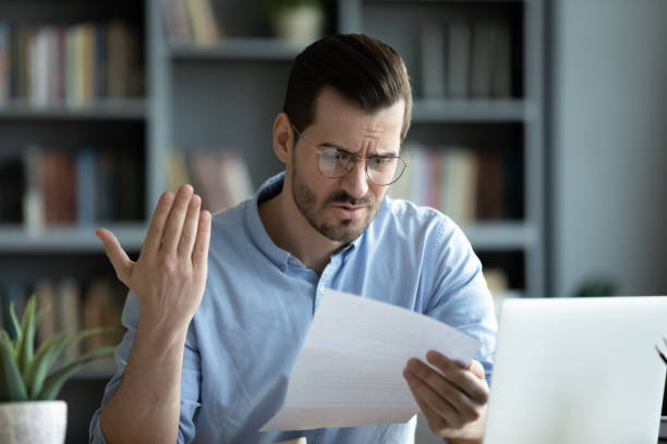istock Unhappy young man read unpleasant message in correspondence 1276837754
