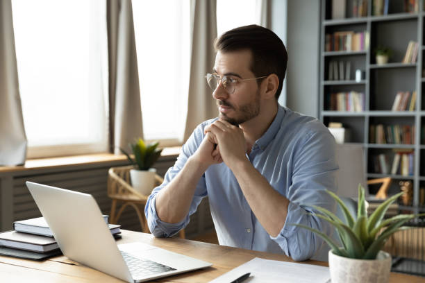 istock Pensive male look in distance think of work problem solution 1276837760