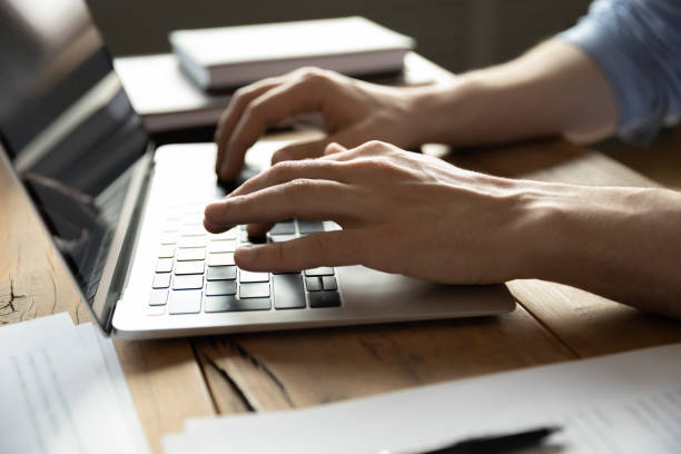 istock Close up of man typing on modern laptop keyboard 1276837762