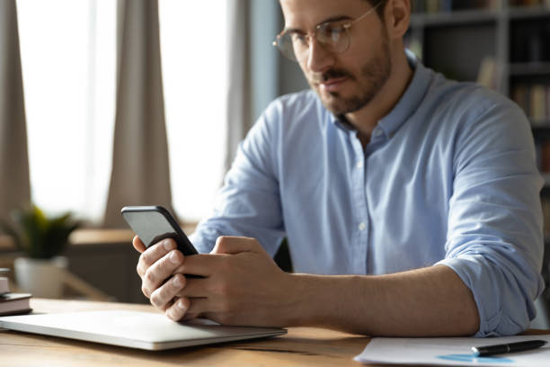istock Close up of Caucasian man using modern smartphone 1276837774