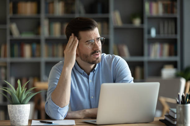 istock Upset young man feel distressed at home workplace 1276837784
