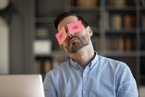 istock Exhausted male employee feel overwhelmed sleeping at workplace 1276837801