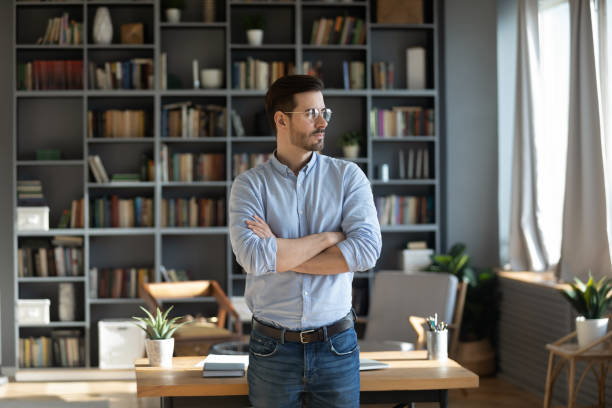 Confident young businessman look in distance making decision