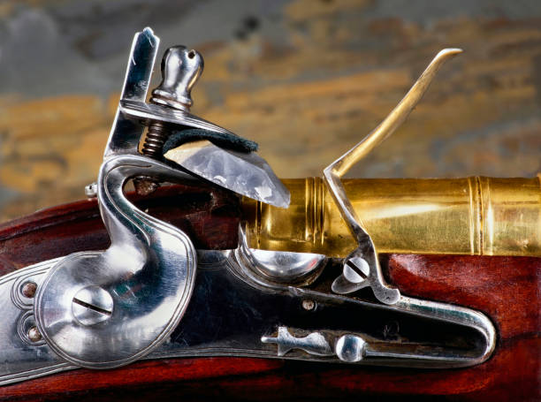 Antique Flintlock Gun. Closeup of antique flintlock gun showing the hammer ,flint , pan and frizzen. rifle old fashioned antique ancient stock pictures, royalty-free photos & images