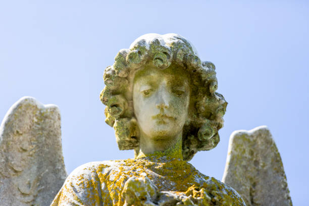 istock Angel, old statue of angle, blue sky background with copy space 1276843289