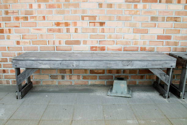 istock old wood bench in front brick wall 1276844339