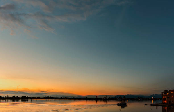 istock dawn over the river with a mountains silhouettes view 1276846260