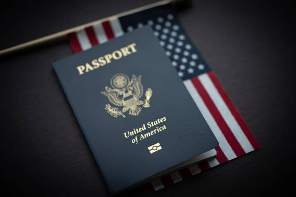 American Flag under Passport of USA. Black Background. stock photo
