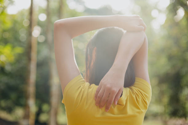 istock Young asian woman stretching her arm and shoulder 1276866391