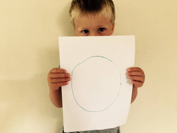 istock Preschool Age Child holds his Circle Drawing 1276867213