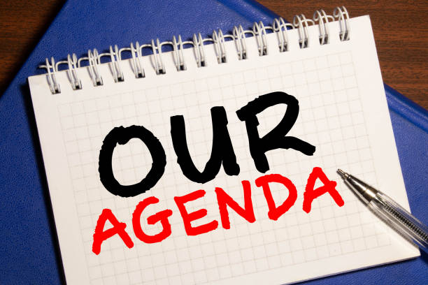 istock Notebook writing Our Agenda, Office table with laptop ,coffee cup,glasses 1276870087