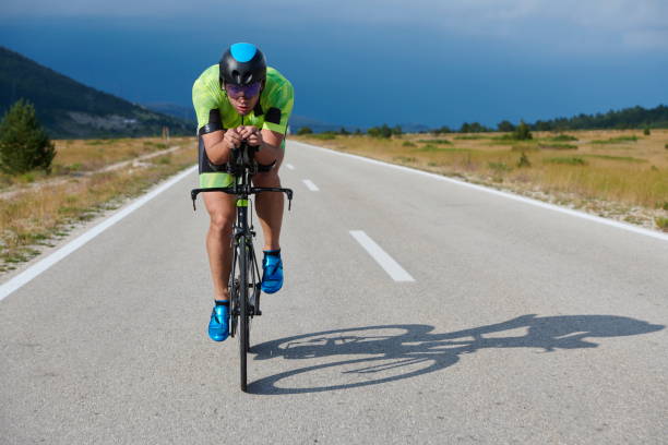 istock triathlon athlete riding bike 1276874480
