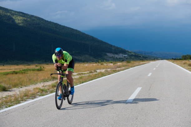 istock triathlon athlete riding bike 1276874485